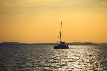 Sailboat floating on the sea during the evening