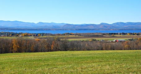 Fototapeta na wymiar Rural Autumn panorama of lake, mountains and countryside