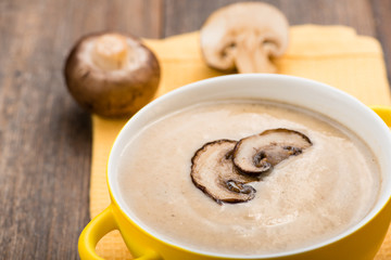 Mushroom cream soup on the wooden table.