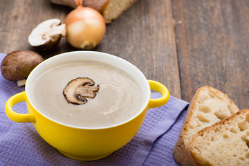 Mushroom cream soup on the wooden table.