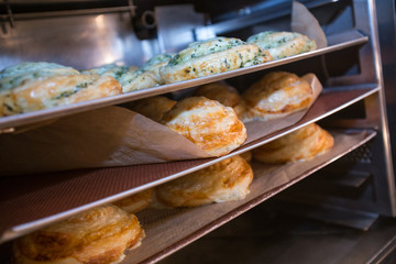 making fresh pizza snacks in a bakery