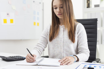 Centered secretary is writing