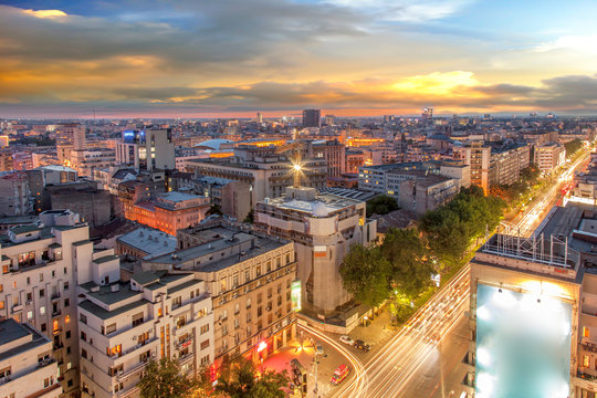 Aerial view of capital city Bucharest, Romania. University Square at sunset with traffic lights.