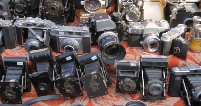 Display of vintage old-fashioned photographic cameras at Portobello market in London