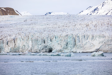 Floating sea ice in front of massive glacier in arctic