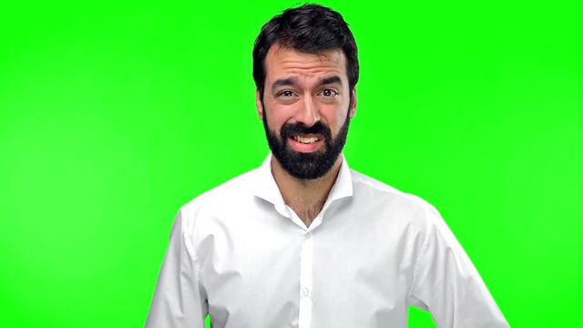 Handsome man making crazy gesture on green screen chroma key