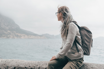 Traveler sitting on coast