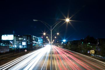 Fototapeta na wymiar Long Exposure of Highway Car Lights Vanishing Into the Distance at Night