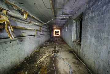Spooky Underground tunnel with asbestos pipework