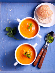 Vegetable soup in a bowls on blue surface
