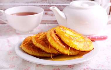 Orange pancakes on plate,