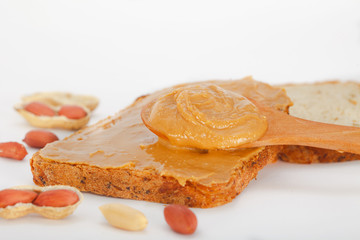 Creamy peanut butter on a slice of toast. Peanut butter sandwich for breakfast.