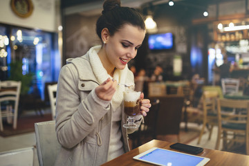 Woman using tablet in restaurant