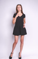 Beautiful young woman with long hair isolated on white. high-heeled shoes.