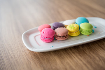 Dessert Macaroon placed in a dish with a wooden background.
