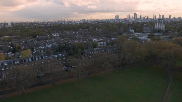 Aerial approaching view of a typical Victorian village in North London with the skyline of London in the background