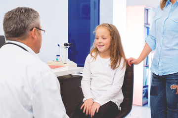 Fototapeta premium Doctor examining a child patient.Colored photo