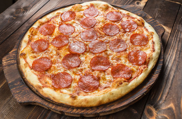 Pepperoni pizza on a board