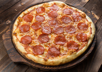 Pepperoni pizza on a board