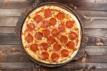 Pepperoni pizza on a board