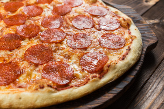 Pepperoni pizza on a board