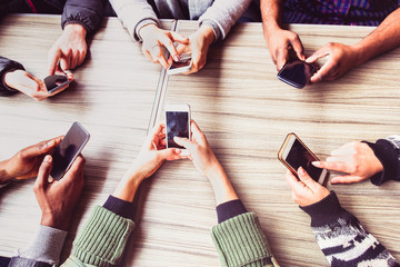 Fototapeta premium Group of friends having fun together with smart phones