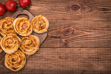 Pizza rolls on wooden board. 