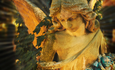 Fototapeta premium Majestic view of statue of golden angel illuminated by sunlight