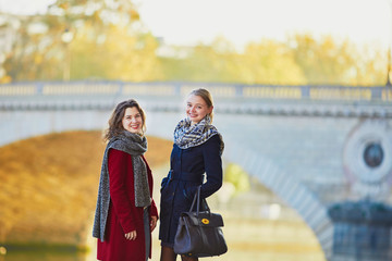 Two young girls walking together in Paris