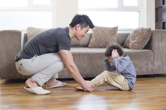 Young father and son exercising at home