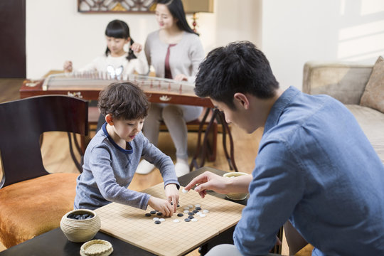 Young father and son exercising at home