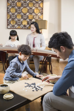 Young father and son exercising at home