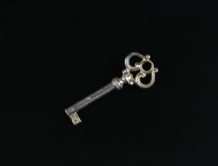 old door key close-up, black background isolated