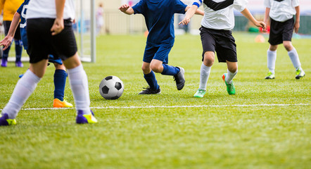 Obraz premium Teenage Soccer Players Playing Match on Sports Field