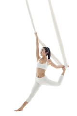 Young woman practicing aerial yoga