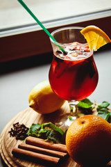 A nice glass of mulled wine with cinnamon sticks, mint and lemon