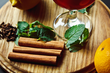 A nice glass of mulled wine with cinnamon sticks, mint and lemon