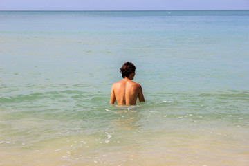 muscular man in the standing inside the water in Thailand