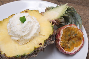 Fruit sorbet ice cream in small pineapple
