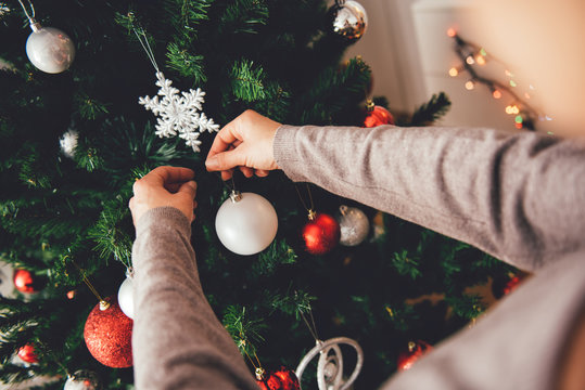 Woman Decorating A Christmas Tree