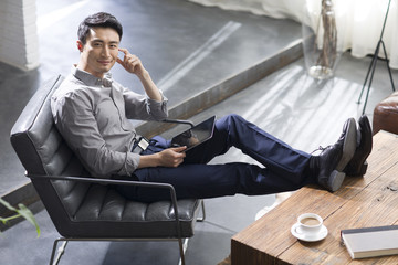 Young man using digital tablet in office