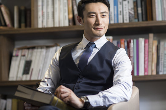 Young businessman thinking in his study
