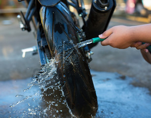 close up washing a motorcycle wheel.