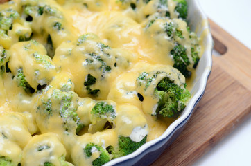 millet casserole with broccoli and cheese in ceramic dish. Close-up and selective focus