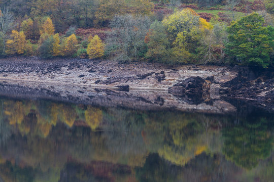Trees, and hill reflected in water, Autumn Fall.