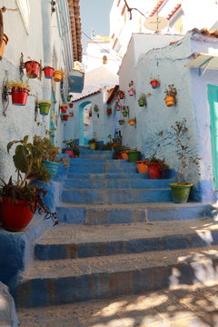 Street full of colorful pots in Chefchaouen, Morocco © juanorihuela