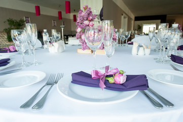 Festive table setting in the restaurant with flowers. Wedding decor.