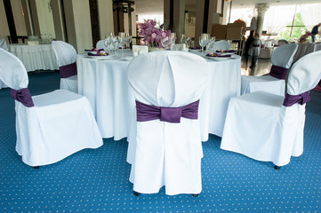 Festive table setting in the restaurant with flowers. Wedding decor.