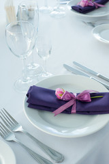 Festive table setting in the restaurant with flowers. Wedding decor.