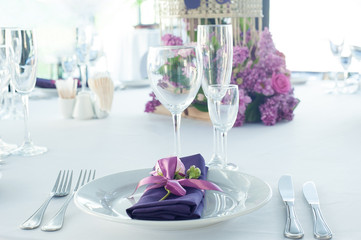 Festive table setting in the restaurant with flowers. Wedding decor.